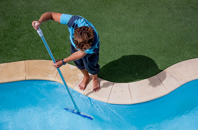 person scrubbing pool